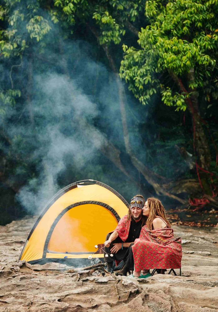 couple-making-smores-when-camping-in-forest-GYKKQGP-2.jpg